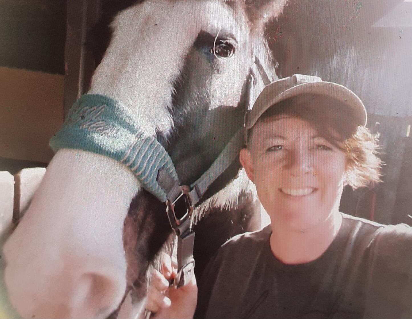 Person posing with a horse.